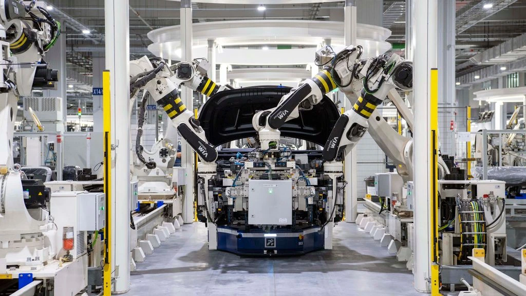 Automotive manufacturing line with robotic welders and overhead conveyors